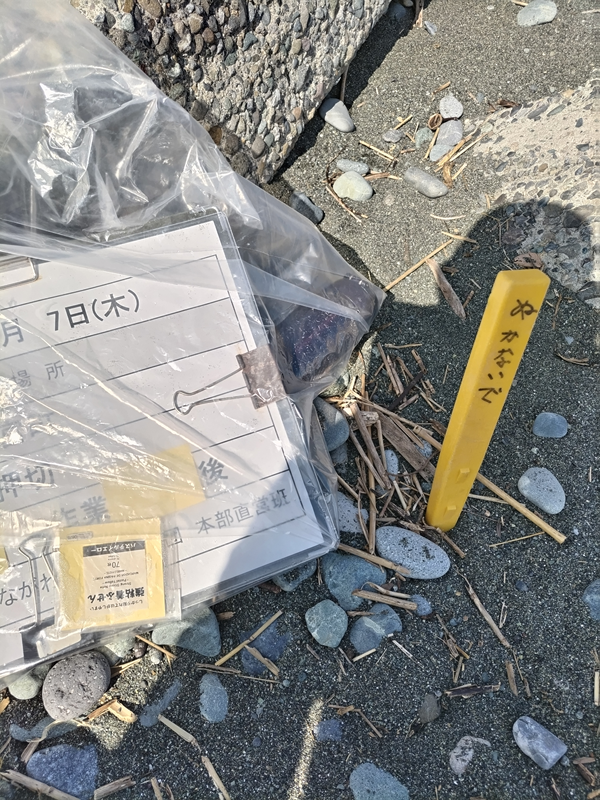 引籠りニートだった齋藤健一が押切海岸にささった黄色い杭と作業用看板を見ているところ