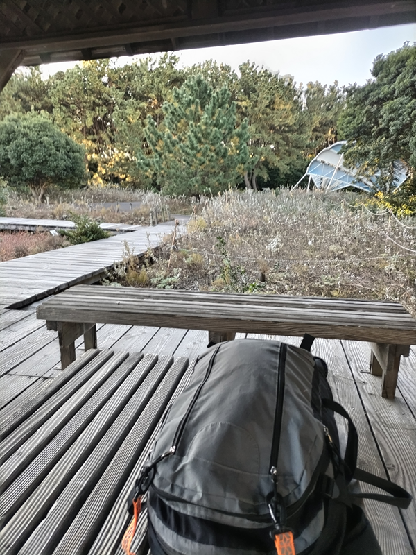 引籠りニートだったセル齋藤が眺めていた自然公園内の木製テーブルの上に置かれた灰色リュック