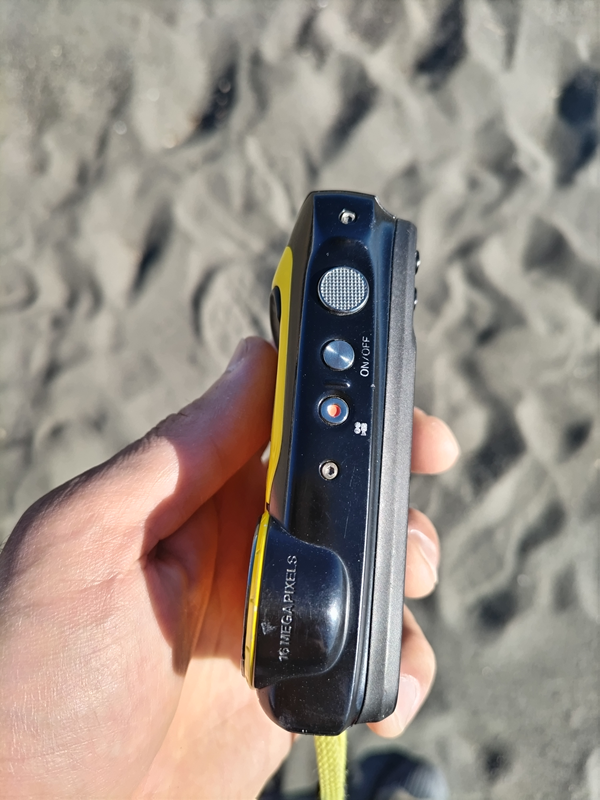 元引籠りが海岸清掃用の仕事で使っていたデジタルカメラの操作ボタンを見ている様子